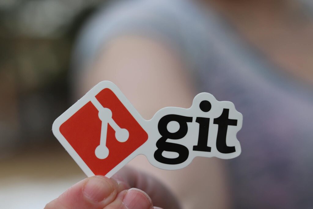 Crafting the Perfect Blog Structure: A Guide for Effective Blogging Close-up of a person holding a Git sticker, emphasizing software development.