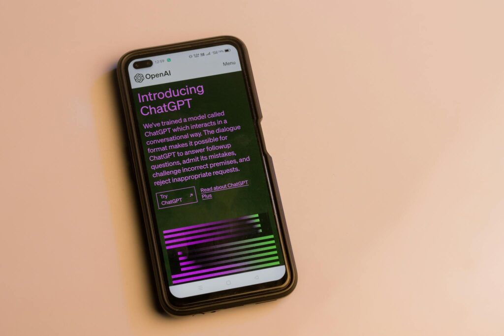 Maximizing Your Blog’s Reach: SEO Tips for Bloggers Smartphone screen showing ChatGPT introduction by OpenAI, showcasing AI technology.